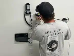 Technician performing Systemic Sealing for scorpion prevention