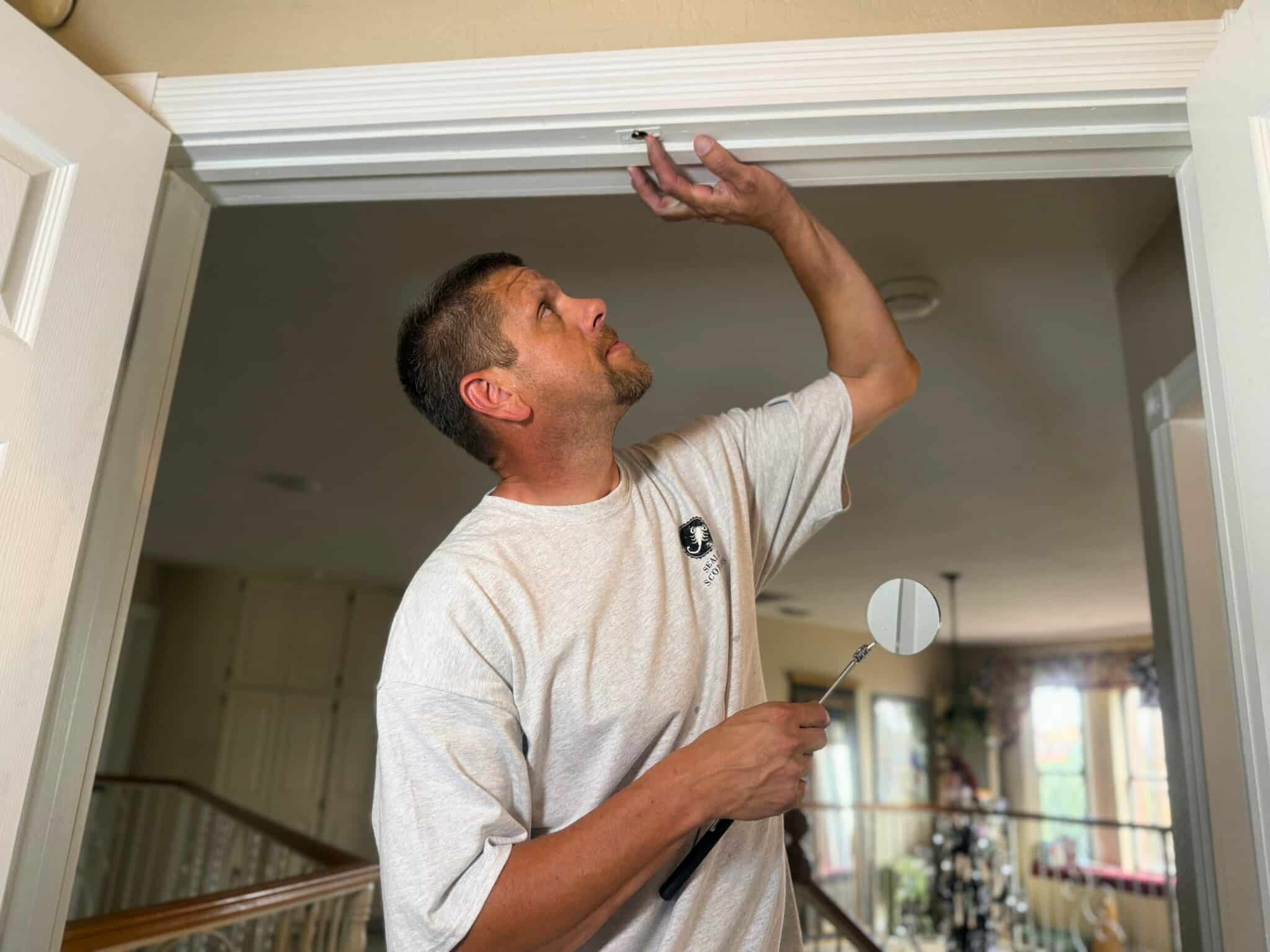 Mike, a Building Performance Sealing expert, inspects and seals a home to ensure scorpion control