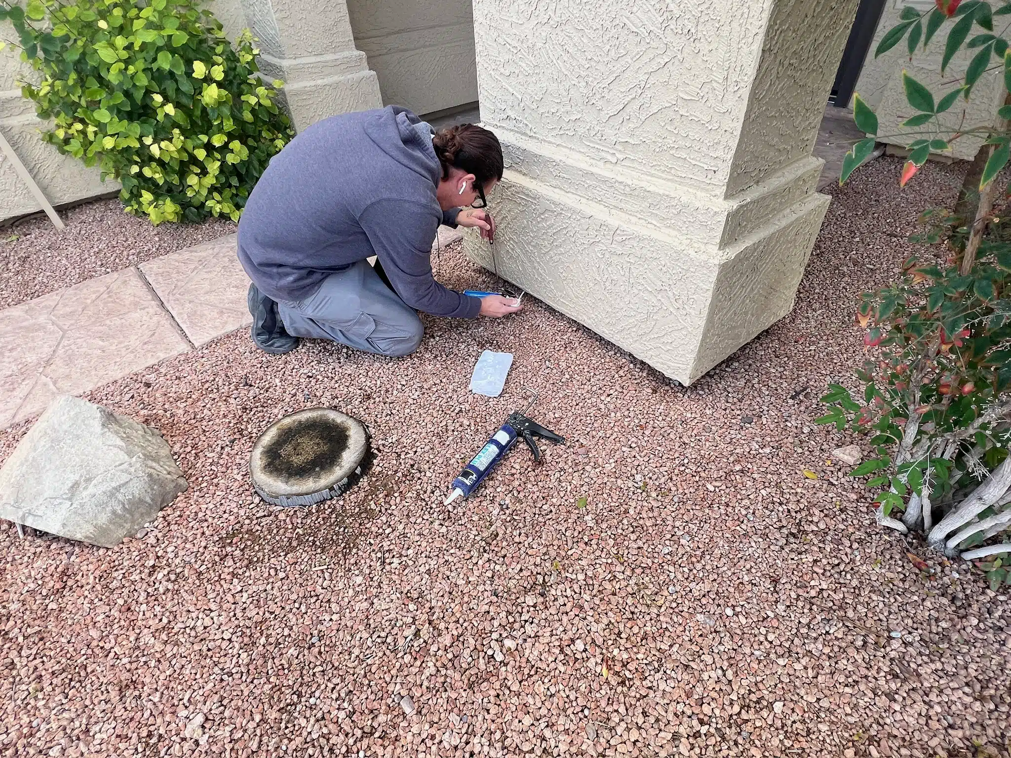 Technician performing scorpion sealing to prevent pests from entering the home.