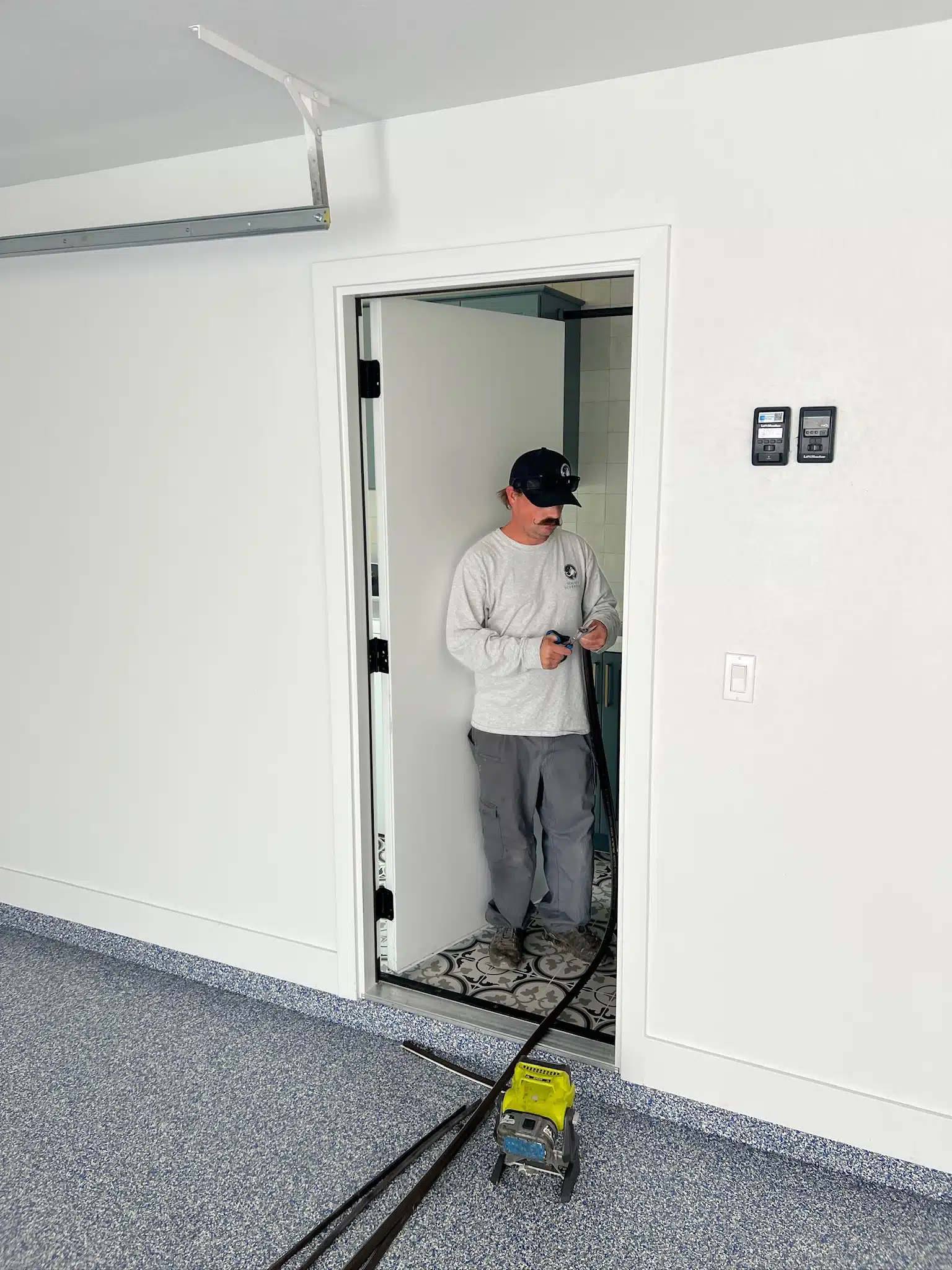 Technician applying sealing around a door to enhance barrier integrity, preventing pest entry and improving home efficiency