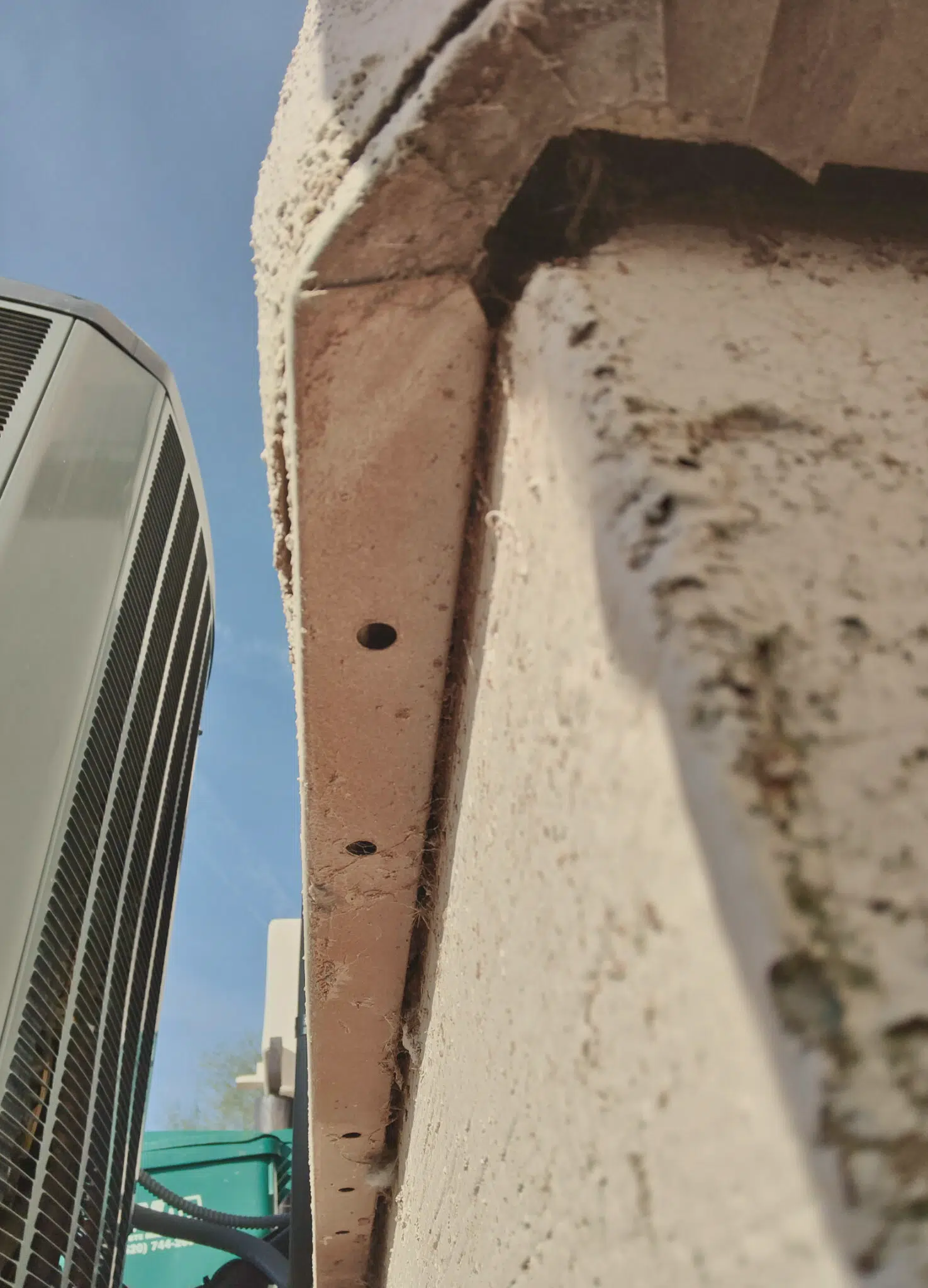Image of scorpion entry point near an HVAC unit, illustrating the importance of structural integrity in scorpion control, beyond traditional spray methods.