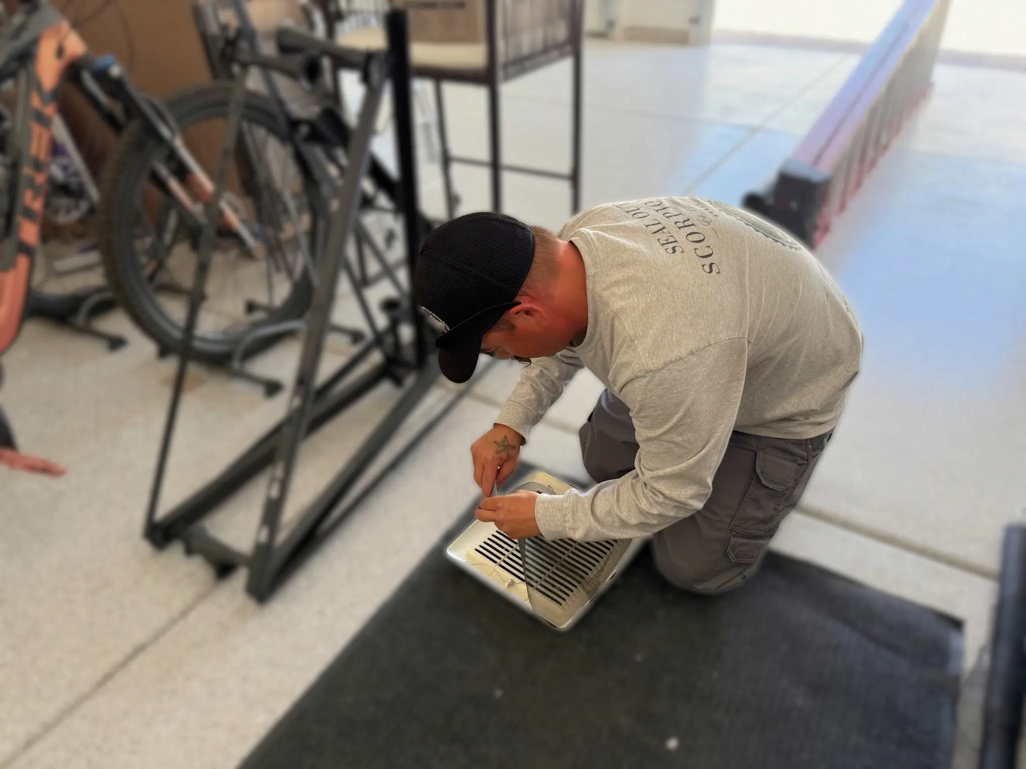 Technician Sealing a Vent for Effective Scorpion Exclusion
